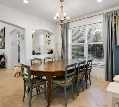 Gather around this welcoming dining table where your group can enjoy meals together in this bright, thoughtfully designed space with charming archways.