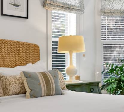 Unwind in this coastal-inspired bedroom with natural textures, soft linens, and gentle morning light filtering through plantation shutters.