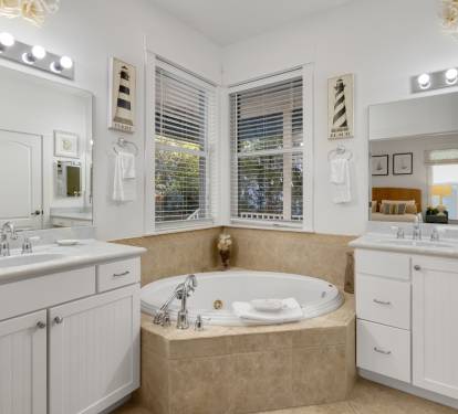 Unwind in your luxurious master bathroom featuring dual vanities, soaking tub, and elegant finishes for ultimate relaxation.