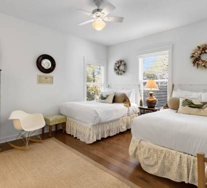 Rest peacefully in your bright twin bedroom with coastal charm, complete with ceiling fan and TV for comfort.