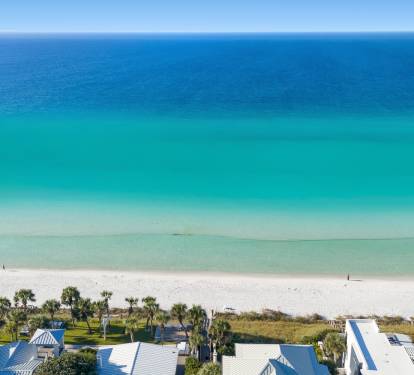 Breathtaking Gulf Coast paradise with pristine white sand beach and crystal-clear turquoise waters stretching endlessly to the horizon.
