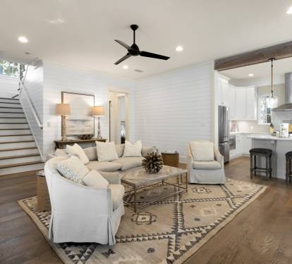Unwind in your stylish open-concept living space where modern comfort meets coastal charm, complete with plush seating and gourmet kitchen.