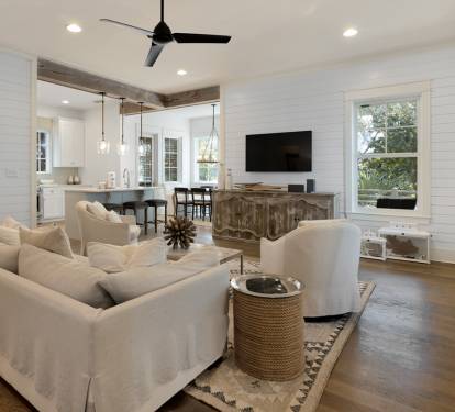 Relax in your bright, open living space with comfy seating, modern kitchen, and charming shiplap walls that create the perfect coastal retreat.