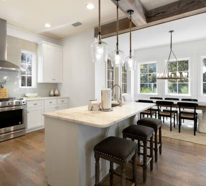 Your dream kitchen awaits with gleaming white cabinets, marble island, and professional appliances perfect for cooking memorable meals together.