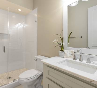 Step into your pristine bathroom where marble countertops and a spacious glass shower create a spa-like retreat for your daily rituals.