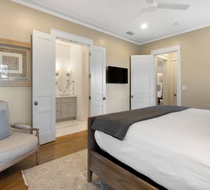 Settle into your elegant bedroom featuring warm wood floors, cozy seating, and your own en-suite bathroom for ultimate comfort.
