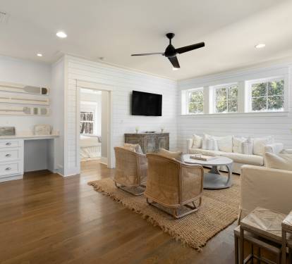 Sink into plush cream seating while natural light streams through large windows, creating your perfect space to unwind and connect.
