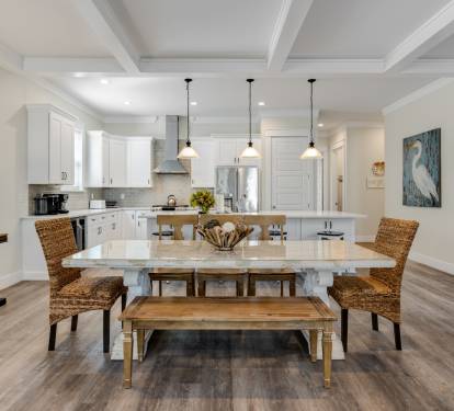 Gather around your elegant dining table in this open-concept space where coastal charm meets modern comfort for memorable meals.