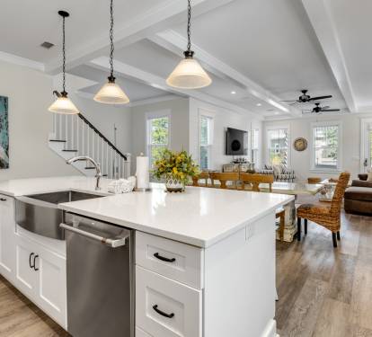 Step into your bright, modern sanctuary where gleaming white counters invite morning coffee preparation and evening meal gatherings.