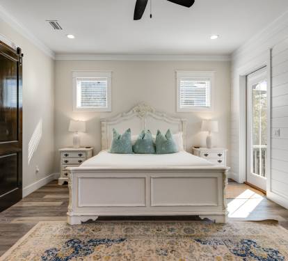 Drift into peaceful dreams in your elegant bedroom sanctuary, featuring coastal-inspired touches and charming barn door details.
