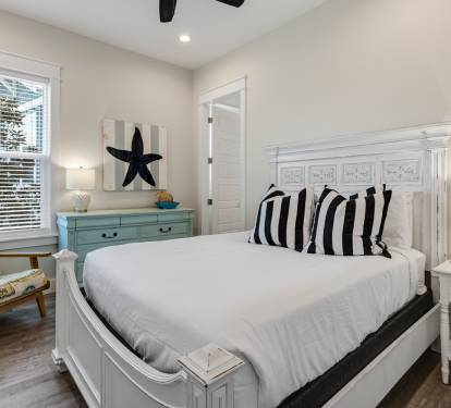 Sink into crisp white linens and nautical charm in your coastal-themed bedroom, where comfort meets style perfectly.
