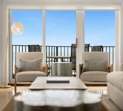 Unwind in your bright living room where soft seating and golden lighting create the perfect retreat after exploring.