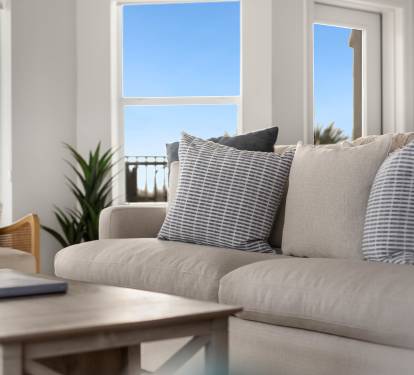 Sink into plush seating while bright ocean views fill your living space through floor-to-ceiling windows.