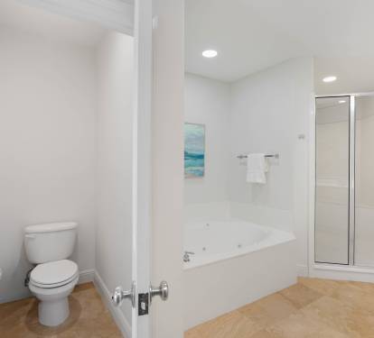 Unwind in your spacious bathroom with a luxurious soaking tub and separate glass shower for ultimate relaxation.