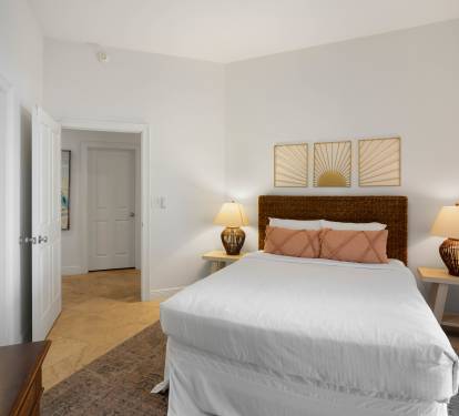Sink into crisp linens and soft pillows in your serene bedroom, where warm lighting and thoughtful touches create the perfect retreat.