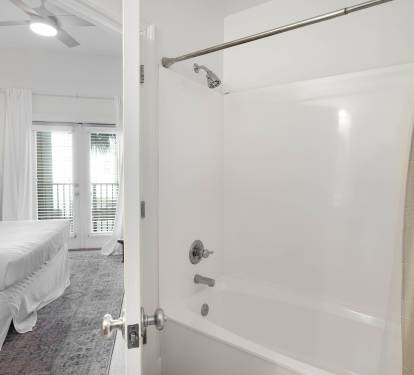 Step into your private spa-like bathroom with pristine white surfaces and a full tub-shower combo, perfect for unwinding after exploring.