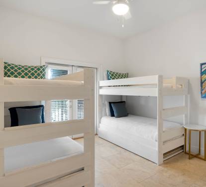 Your kids will love these cheerful bunk beds, perfectly set up for a cozy night's sleep after beach adventures.