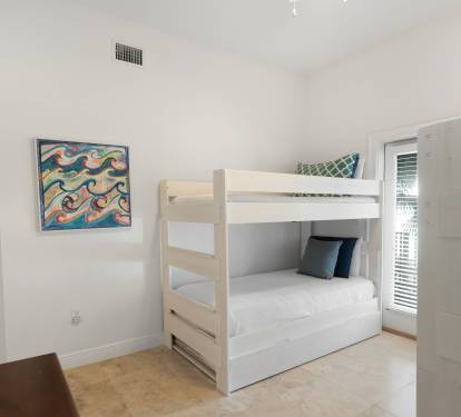 Your kids will love this bright bunk room with crisp white linens and ocean-themed art, perfect for bedtime stories.