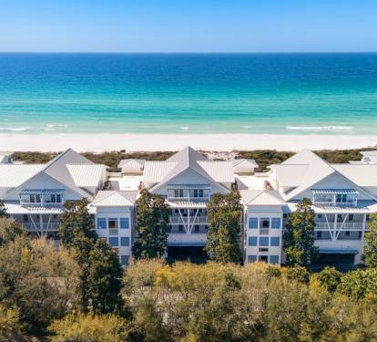 Beachfront vacation homes with pristine white sand and turquoise waters just steps away from the property.