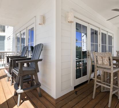Your covered balcony offers the perfect spot to unwind with morning coffee or evening drinks, featuring comfortable seating and dining space.