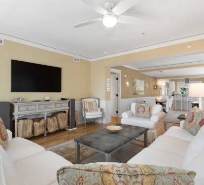 Unwind in your spacious living room featuring plush seating, warm lighting, and entertainment center for memorable evenings together.