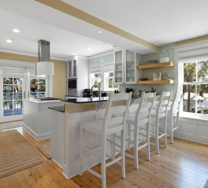 Your bright kitchen island becomes the heart of your stay, with bar seating for six and tropical views through the windows.