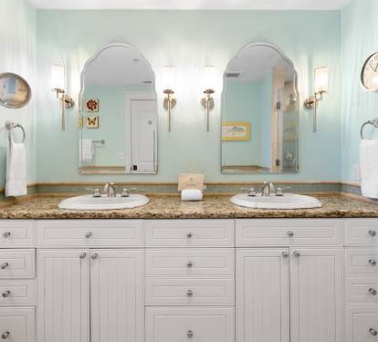 Step into your private spa-like bathroom with dual vanities, granite countertops, and soothing coastal colors that make getting ready a luxurious experience.