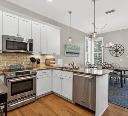 Your fully equipped kitchen flows seamlessly into the dining area, where natural light and modern fixtures create the perfect space for home-cooked meals.
