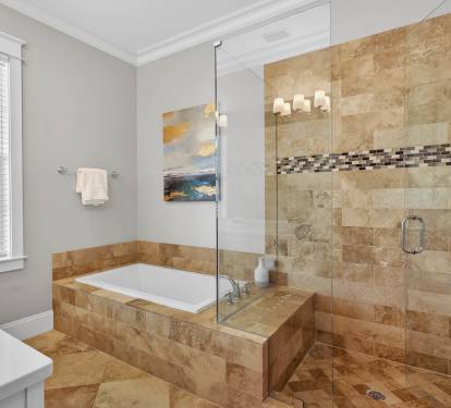 Unwind in your luxurious master bathroom featuring a spacious glass shower and elegant soaking tub, perfect for relaxing after your adventures.