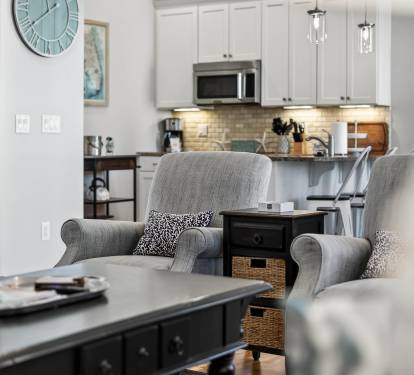 Sink into these plush armchairs and feel instantly at home in your thoughtfully designed open-concept space, where the modern kitchen awaits your culinary adventures.