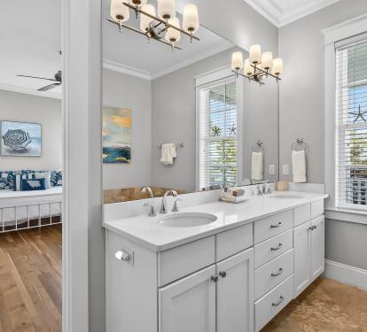 Pamper yourself in this elegant bathroom with dual vanities, perfect for getting ready together on your beach getaway.