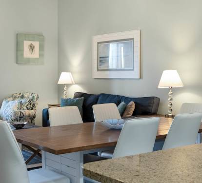 Gather around your elegant dining table for memorable meals, with comfortable seating and warm lighting creating the perfect atmosphere for your stay.