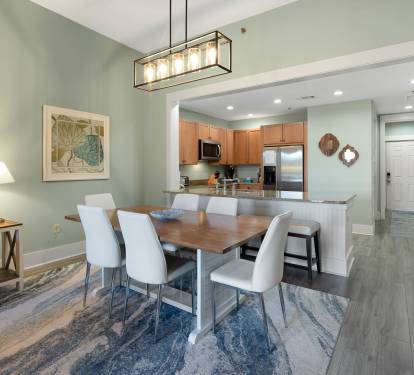 Your elegant open-plan dining and kitchen awaits with modern fixtures, warm lighting, and space for memorable meals together.