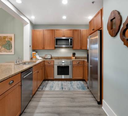 Your modern kitchen features granite countertops, stainless steel appliances, and warm wood cabinets perfect for preparing memorable meals.