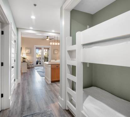 Rest peacefully in your private bunk room featuring modern built-in beds with crisp linens and calming gray tones.