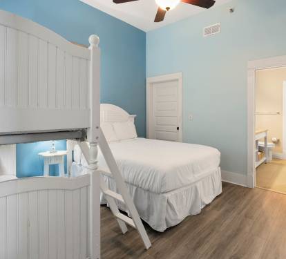 Rest peacefully in your coastal bedroom with crisp white linens and cheerful blue walls that create a calming seaside retreat.