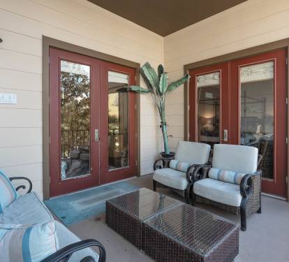 Step onto your private patio where coastal-style seating invites you to unwind with morning coffee or evening conversations in complete comfort.