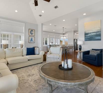 Sink into the plush sectional sofa where coastal blues meet creamy whites, creating your perfect retreat for morning coffee or evening conversations.