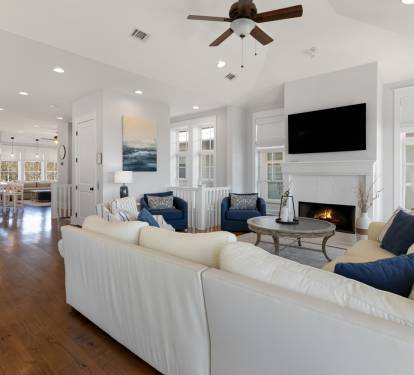 Relax in this bright, open living space featuring plush seating, a cozy fireplace, and seamless flow to your fully equipped kitchen.