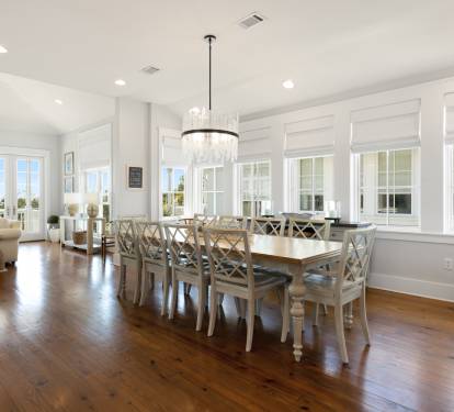 Gather around this elegant dining table where warm hardwood floors and crystal chandelier create perfect moments for your memorable meals together.