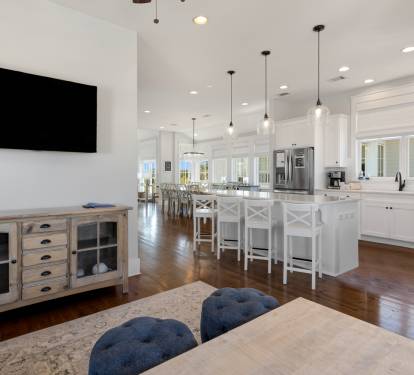 You'll love the open-concept design where living, dining, and kitchen flow seamlessly together with stylish furnishings and modern appliances for perfect group gatherings.