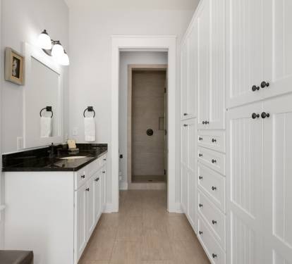 Refresh in your elegant bathroom with dual vanities, black granite counters, and abundant storage for all your essentials.