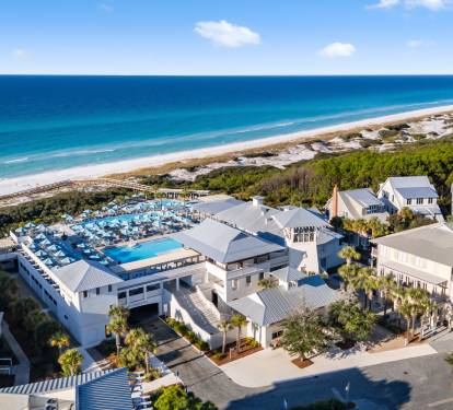 Stunning beachfront resort featuring pristine white sand beaches, crystal blue waters, and elegant coastal architecture surrounded by lush tropical vegetation.