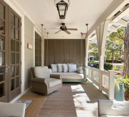 Relax on your private covered porch with comfortable seating, ceiling fans, and peaceful garden views.