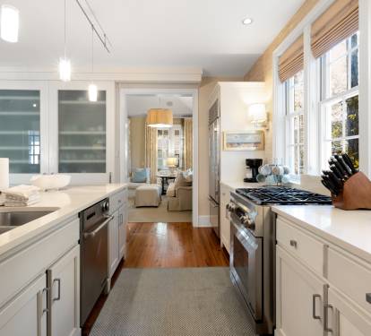 You'll love cooking in this bright, elegant kitchen with premium appliances, gleaming countertops, and abundant natural light streaming through large windows.