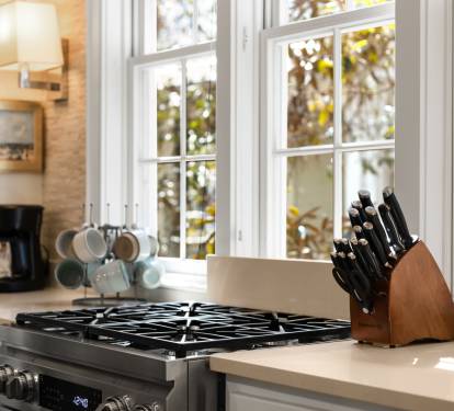 Your fully-equipped kitchen invites culinary adventures with professional-grade appliances, quality knife set, and sunlit workspace overlooking peaceful garden views.