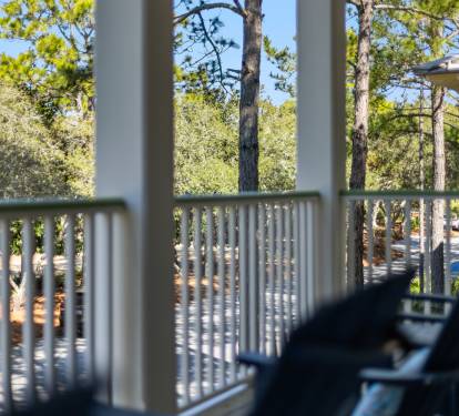 Relax on your private balcony surrounded by towering pine trees, where dappled sunlight creates the perfect retreat for your morning coffee.