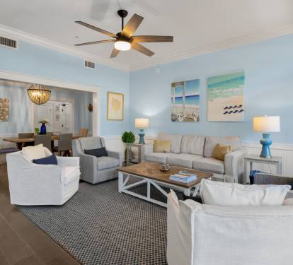 Unwind in your spacious coastal living room with plush seating and calming beach artwork that creates the perfect atmosphere for relaxation.