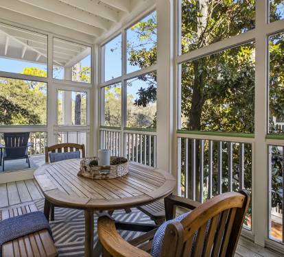 Enjoy morning coffee or afternoon meals in your private screened porch, where sunlight filters through mature trees and gentle breezes flow through.