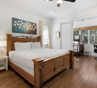 Relax in your peaceful bedroom with rich hardwood floors, custom wooden furnishings, and crisp linens for perfect rest.